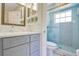 Bright bathroom with marble countertop, shower and glass door, and ample cabinet space at 2095 Curry Ln, Orlando, FL 32812