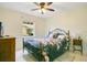 Cozy bedroom with floral bedding, tile flooring, and a ceiling fan for added comfort at 2095 Curry Ln, Orlando, FL 32812