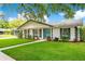 Inviting single-story home featuring a lush green lawn, tidy landscaping, and an attached garage at 2095 Curry Ln, Orlando, FL 32812