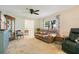 Cozy living room with hardwood floors, comfortable seating, and natural light from a large window at 2095 Curry Ln, Orlando, FL 32812