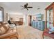 Open-concept living room featuring tile floors, a ceiling fan, and a view into the dining area at 2095 Curry Ln, Orlando, FL 32812