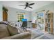 Bright office space featuring a comfortable couch and an efficient workspace with a ceiling fan at 2095 Curry Ln, Orlando, FL 32812