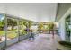 Relaxing enclosed patio with a charming swing, perfect for enjoying the outdoors in comfort at 2095 Curry Ln, Orlando, FL 32812