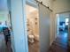 Bathroom with modern sliding door, tiled floors, and a combined shower and tub at 2167 Kerwood Loop, The Villages, FL 32162
