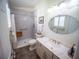 Updated bathroom boasts shower with bench, new vanity with solid surface counters and new fixtures at 2167 Kerwood Loop, The Villages, FL 32162