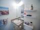 This bathroom offers a single sink, storage cabinets and drawers and tasteful decor at 2167 Kerwood Loop, The Villages, FL 32162