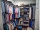 Walk-in closet offers ample storage with built-in shelves and hanging rods at 2167 Kerwood Loop, The Villages, FL 32162
