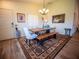 Bright dining room featuring a rustic wooden table, comfortable seating, and stylish decor for Gathering meals at 2167 Kerwood Loop, The Villages, FL 32162