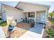 Welcoming front porch with a cozy seating area, decorative plants, and inviting entrance to the house at 2167 Kerwood Loop, The Villages, FL 32162