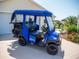 This street legal golf cart has black rims and seats and an all weather enclosure at 2167 Kerwood Loop, The Villages, FL 32162