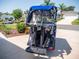Bintelli 6 passenger golf cart featuring a blue exterior, custom seat and clear weather enclosure at 2167 Kerwood Loop, The Villages, FL 32162