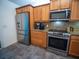 Close up of kitchen with stainless steel appliances, wood cabinets and granite countertops at 2167 Kerwood Loop, The Villages, FL 32162
