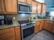 Updated kitchen features granite counters, stainless steel appliances, and wood cabinetry at 2167 Kerwood Loop, The Villages, FL 32162