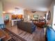 Open floor plan connects kitchen to living room with hardwood floors and vaulted ceilings at 2167 Kerwood Loop, The Villages, FL 32162