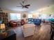 Spacious living room with modern furnishings, ample seating, and plenty of natural light for relaxation and entertainment at 2167 Kerwood Loop, The Villages, FL 32162