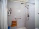 Accessible shower with bench seating, hand-held wand, and safety bar at 2167 Kerwood Loop, The Villages, FL 32162