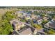 An aerial view showcases the community's colorful townhomes and landscaped streets surrounding a serene lake at 2208 San Vittorino Cir # 104, Kissimmee, FL 34741