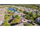 A community aerial view of manicured landscaping surrounding amenities, a pool, and a tranquil lake at 2208 San Vittorino Cir # 104, Kissimmee, FL 34741