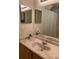 Cozy bathroom features a mirrored vanity and shower with tub combo at 2208 San Vittorino Cir # 104, Kissimmee, FL 34741