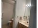 Well-lit bathroom with vanity, faucet, and toilet at 2208 San Vittorino Cir # 104, Kissimmee, FL 34741
