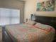 Comfortable bedroom featuring a large bed and window with blinds at 2208 San Vittorino Cir # 104, Kissimmee, FL 34741