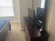 Bedroom dresser with TV and mirror next to bed at 2208 San Vittorino Cir # 104, Kissimmee, FL 34741