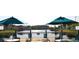 Deck with tables, chairs, umbrellas, and a beautiful view of a lake and other community homes at 2208 San Vittorino Cir # 104, Kissimmee, FL 34741