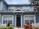 Charming two-story townhome with blue siding and a well-kept front yard at 2208 San Vittorino Cir # 104, Kissimmee, FL 34741