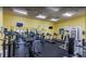 Bright community gym with treadmills, elliptical machines, weight machines and ceiling fans at 2208 San Vittorino Cir # 104, Kissimmee, FL 34741
