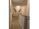 Carpeted hallway with decorative wall art and a staircase at 2208 San Vittorino Cir # 104, Kissimmee, FL 34741