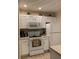 Bright kitchen with white cabinets, appliances, and a functional layout at 2208 San Vittorino Cir # 104, Kissimmee, FL 34741