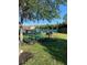 Relaxing community picnic area with green tables, a grill, and pool views, perfect for outdoor gatherings at 2208 San Vittorino Cir # 104, Kissimmee, FL 34741
