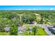 Aerial view of home in a neighborhood featuring lush green landscaping and the city skyline at 228 Ring Rd, Orlando, FL 32811