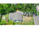 Aerial view of a home with a new roof surrounded by lush greenery at 228 Ring Rd, Orlando, FL 32811