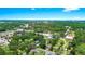 Aerial view of the home with lush foliage and the city skyline on the horizon at 228 Ring Rd, Orlando, FL 32811