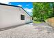 Exterior backyard featuring a gravel area, white exterior paint, and two white doors at 228 Ring Rd, Orlando, FL 32811