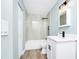 Bathroom features updated vanity, fixtures, and lighting with tile surround in shower at 228 Ring Rd, Orlando, FL 32811