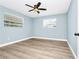 Bedroom featuring wood-look flooring and natural lighting from two windows at 228 Ring Rd, Orlando, FL 32811