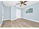 Bedroom with a ceiling fan, wood-look flooring, a window, and a closet at 228 Ring Rd, Orlando, FL 32811