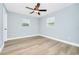 Bedroom featuring a ceiling fan, two windows and wood-look floors at 228 Ring Rd, Orlando, FL 32811