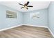 Bedroom featuring wood-look flooring and two windows bringing in lots of light at 228 Ring Rd, Orlando, FL 32811