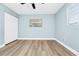 Bedroom features wood-look flooring, a window, and a closet at 228 Ring Rd, Orlando, FL 32811