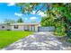 Inviting single-story home with charming curb appeal, featuring a well-manicured lawn and a brick paved driveway at 228 Ring Rd, Orlando, FL 32811