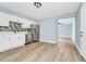 Open-concept kitchen with stainless steel appliances, complemented by modern cabinets and a flowing layout into dining area at 228 Ring Rd, Orlando, FL 32811