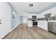 Well-appointed kitchen equipped with stainless steel appliances and modern cabinetry, merging seamlessly into a spacious dining area at 228 Ring Rd, Orlando, FL 32811