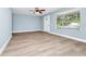 Living room featuring new floors, fresh paint, and large picture window at 228 Ring Rd, Orlando, FL 32811