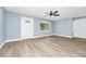 Living room featuring a front door, neutral paint, modern ceiling fan, and wood-look flooring at 228 Ring Rd, Orlando, FL 32811