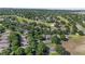 An aerial view showcasing a community with mature trees, houses and golf course at 2309 Edmonton Ct, Clermont, FL 34711
