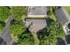 A high-angle aerial view of the home's roof and surrounding mature landscaping, providing shade and privacy at 2309 Edmonton Ct, Clermont, FL 34711