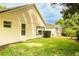 Expansive backyard featuring lush green lawn and views of screened enclosure and mature trees at 2309 Edmonton Ct, Clermont, FL 34711